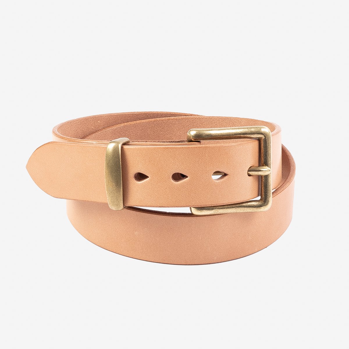 Natural tan leather belt with brass rectangular buckle, rolled up against white background