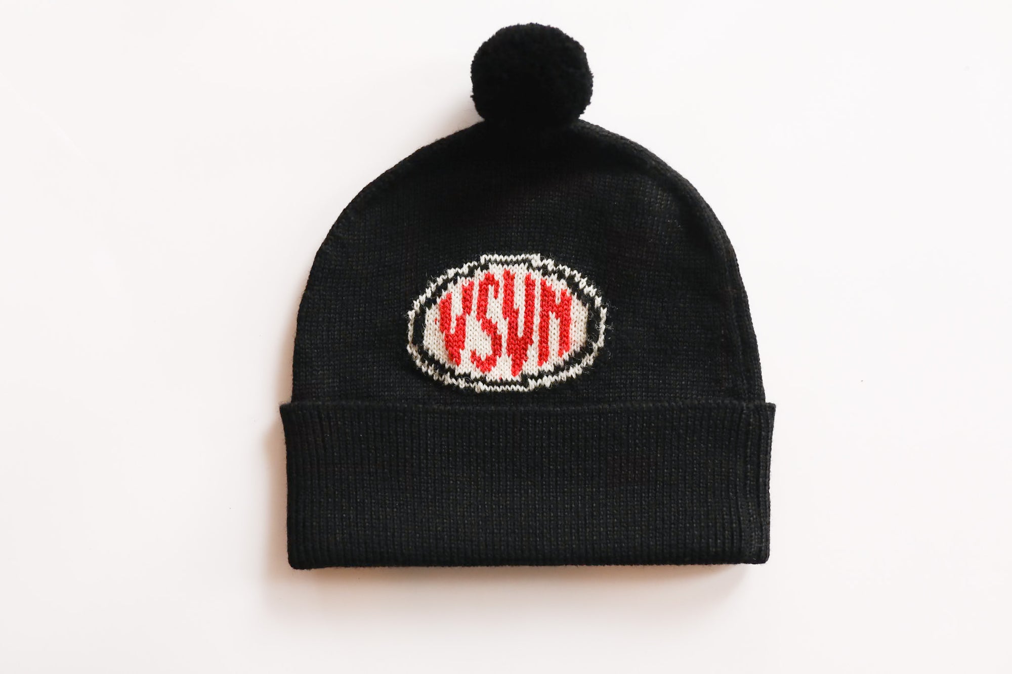 Black beanie with a pom-pom and pixelated logo on a white background