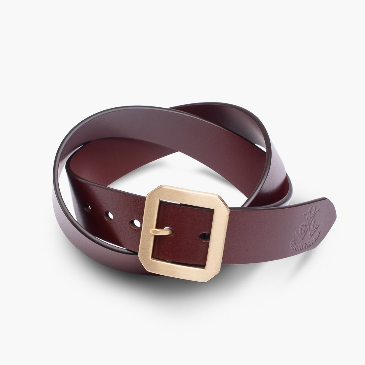 Brown leather belt with square brass buckle neatly coiled on white background