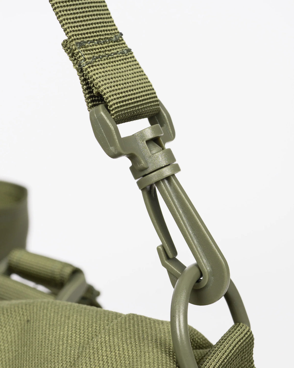 Close-up of an olive green nylon bag strap with a matching metal carabiner clip and ring hardware, shown against a light gray background.