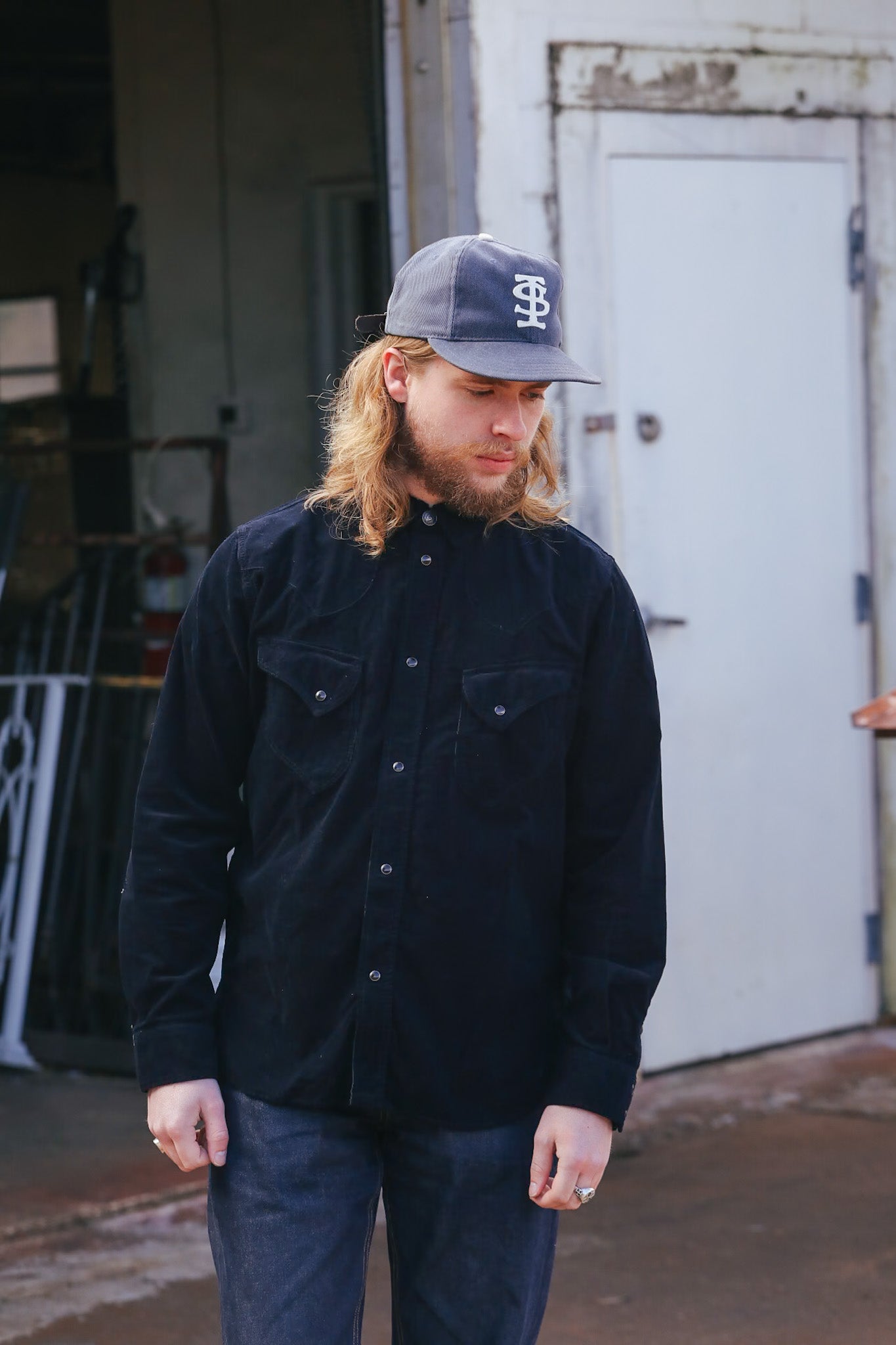man wearing black corduroy western shirt