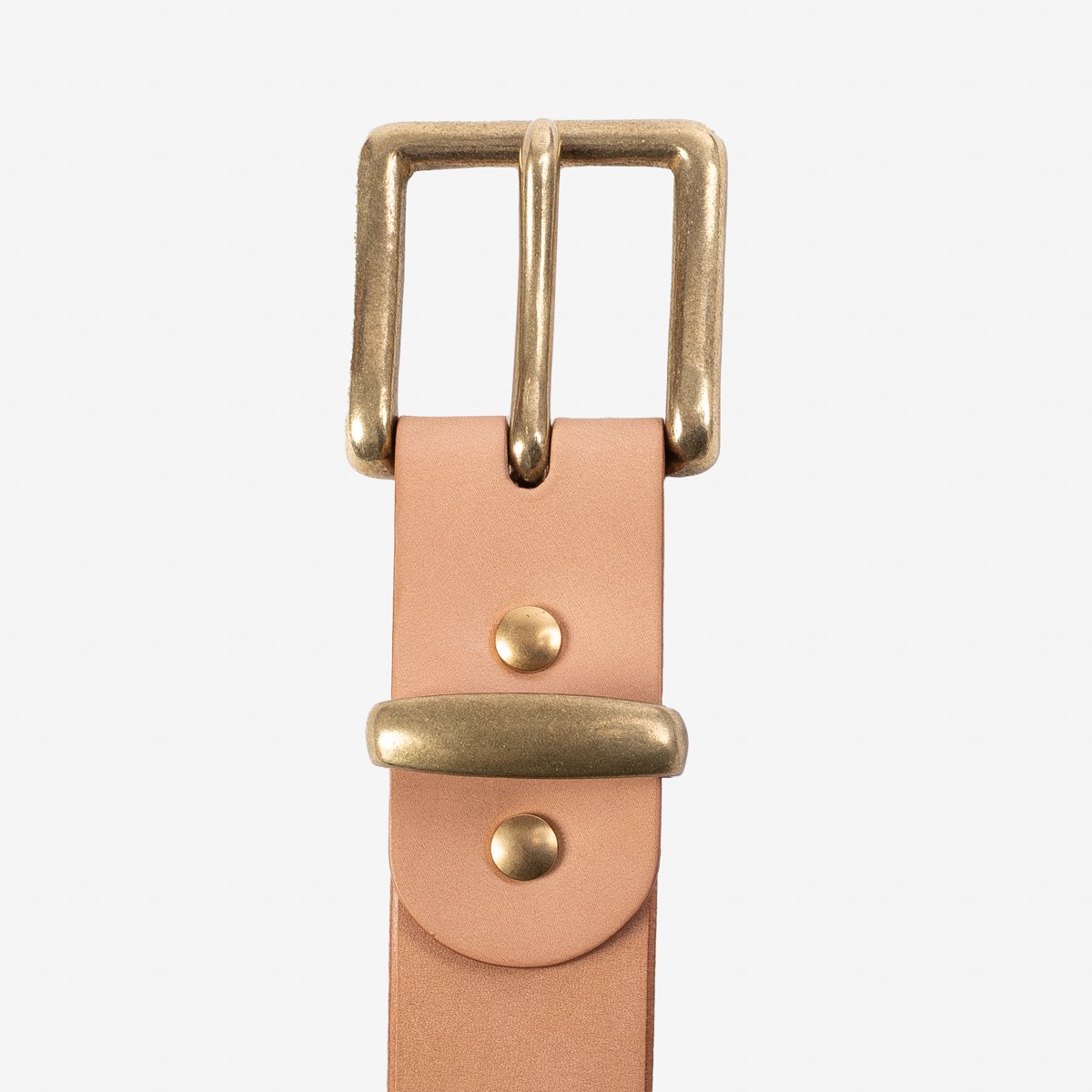 Natural leather belt with brass buckle and rivets on white background