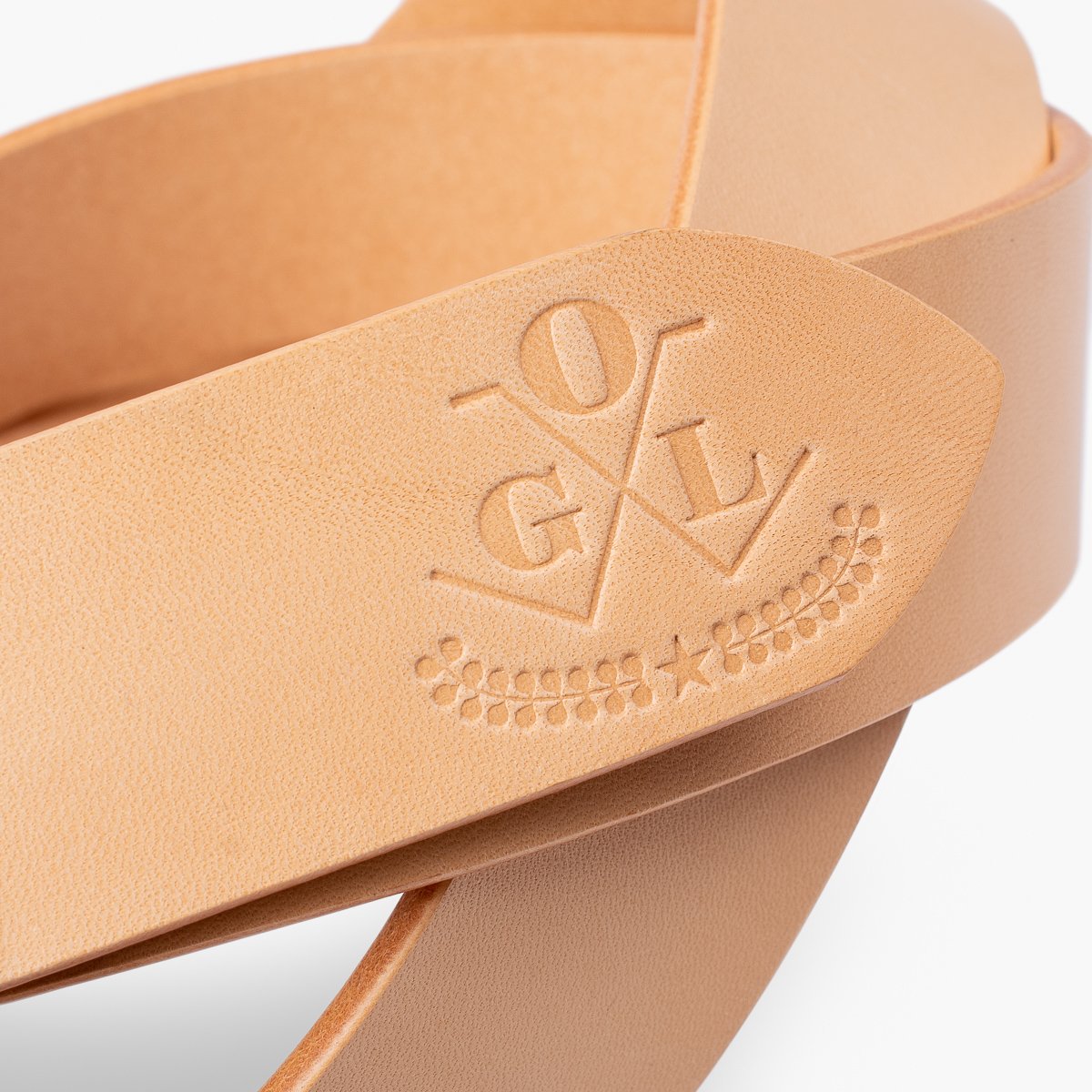 Natural tan leather belt strap embossed with OGVL logo and decorative design, Iron Shop Provisions