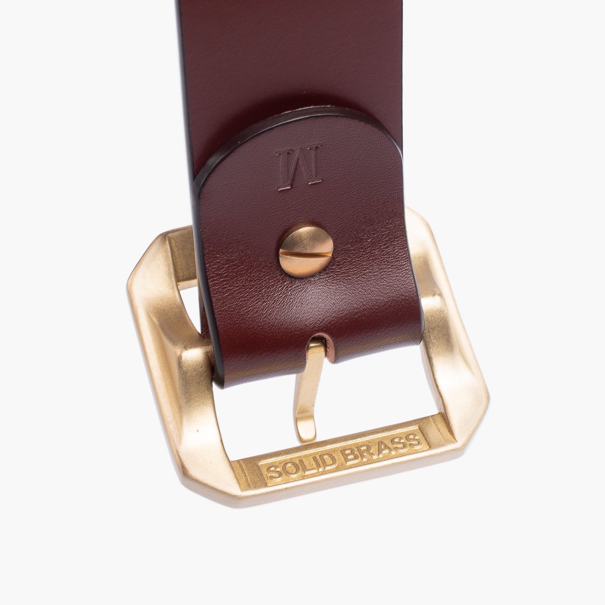 Close-up of brown leather belt with solid brass buckle engraved with "SOLID BRASS"