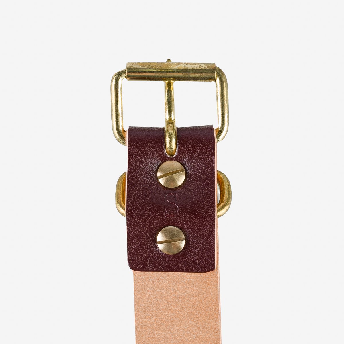 Close-up of leather belt with brass buckle and dark brown leather loop from Iron Shop Provisions