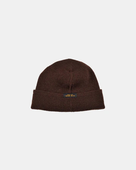 Dehen 1920 wool knit watch cap in brown with folded cuff and small black label, isolated on light background