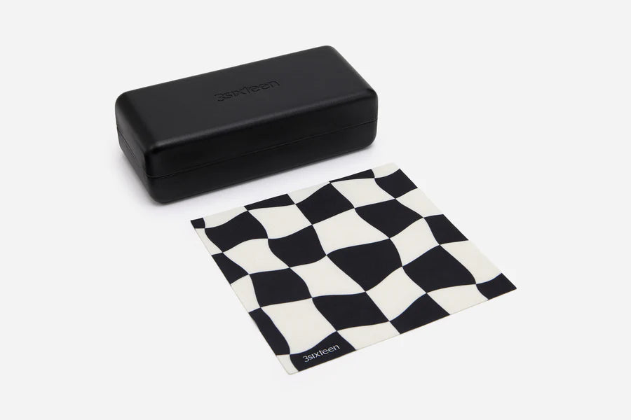 Black rectangular sunglasses case and black-and-white checkered cleaning cloth branded 3sixteen