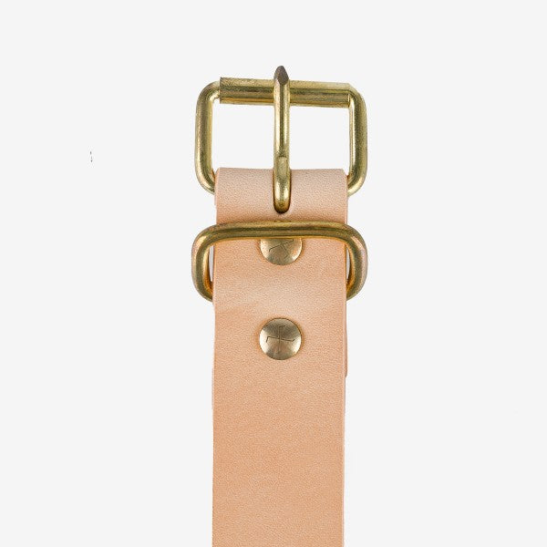 Close-up of natural leather belt with brass buckle and rivets from Iron Shop Provisions