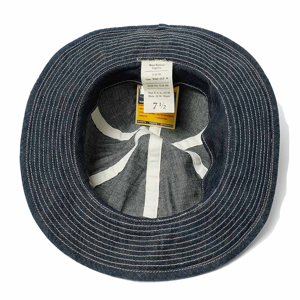 Blue denim hat with a label inside on a white background