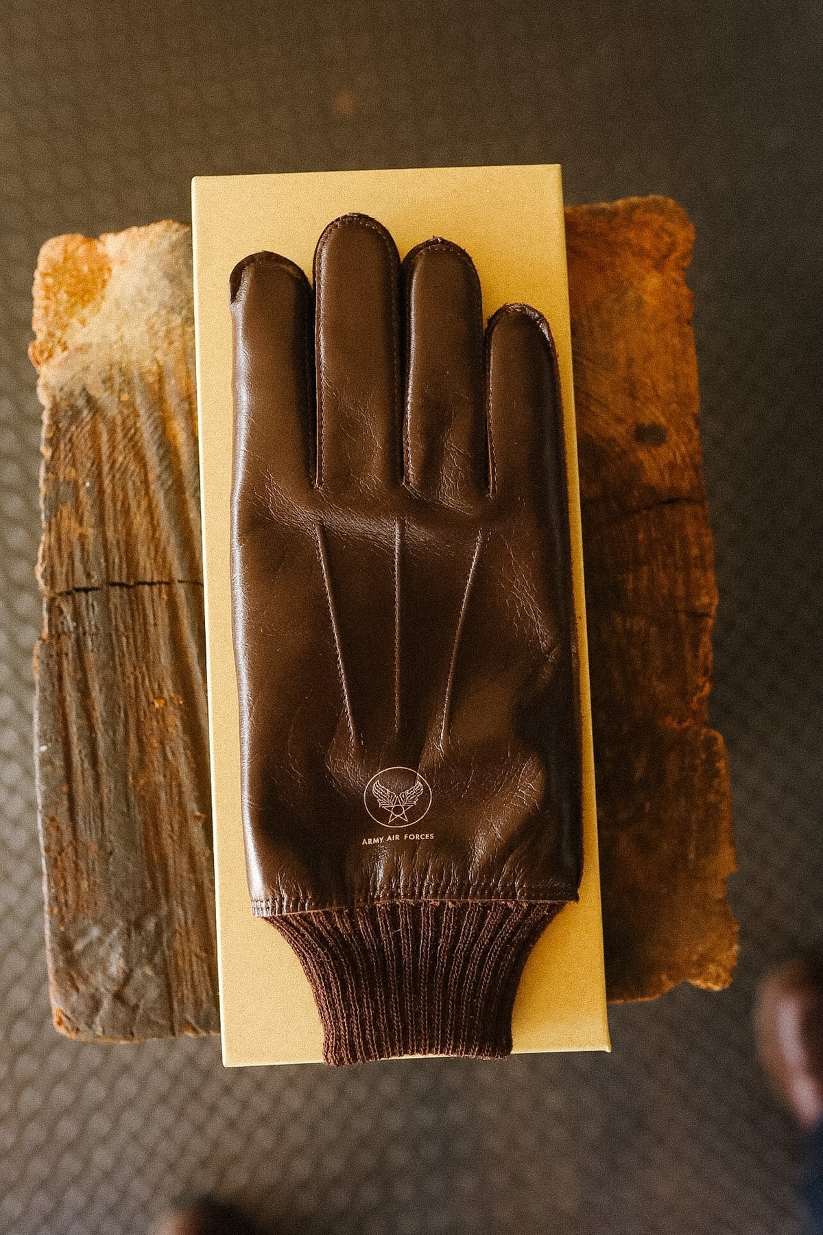 brown leather gloves on a yellow background