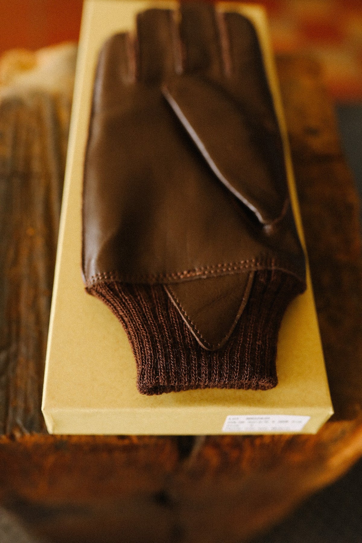 brown leather gloves on a yellow background