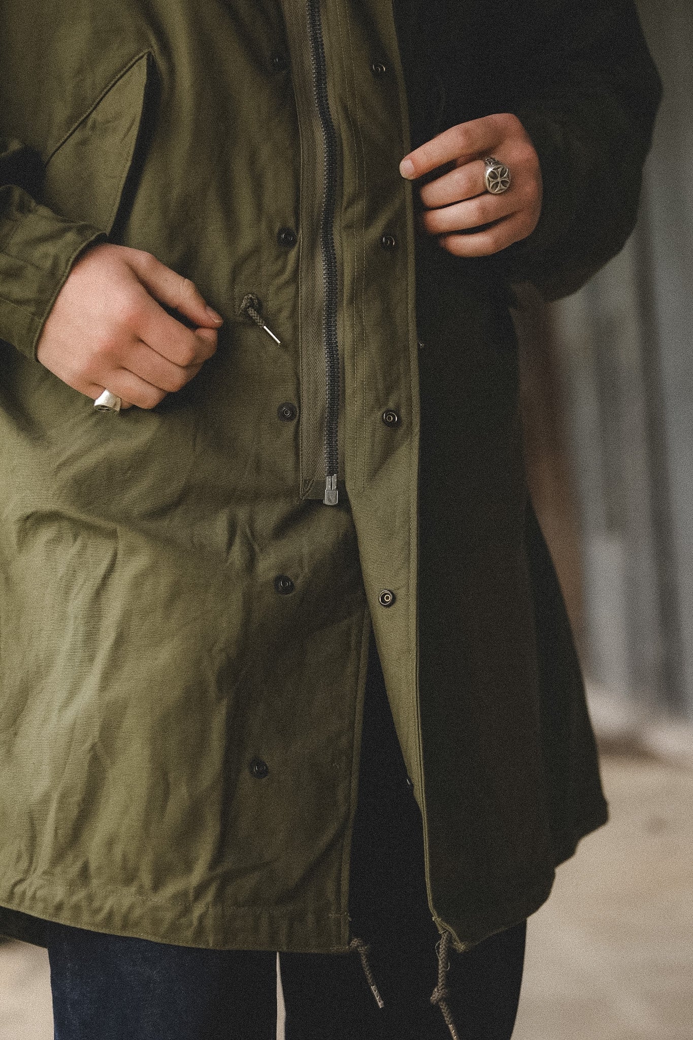 Person wearing a green parka with a blurred background