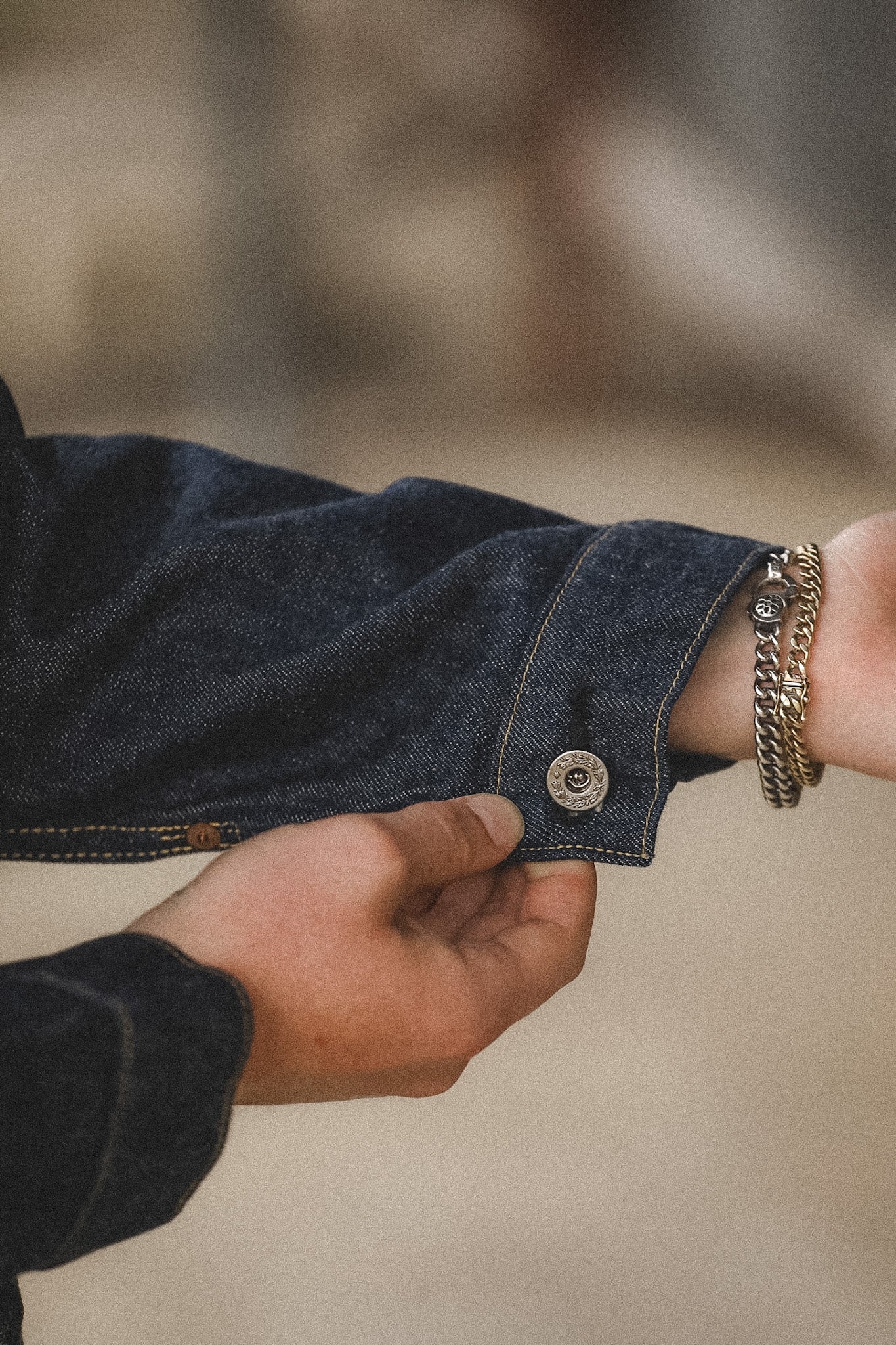 Close-up of a hand wearing a bracelet with a blurred background