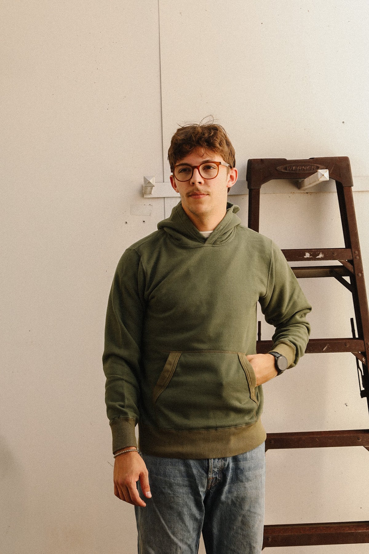 man wearing a green hooded sweater