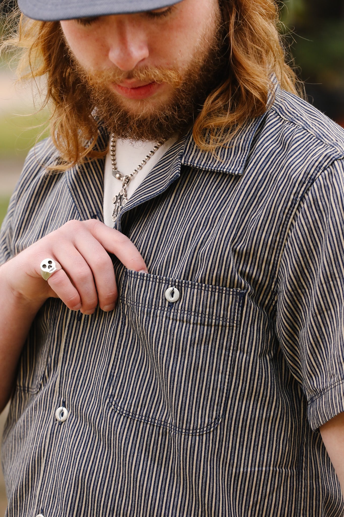 Man wearing a striped shirt with a focus on the chest area