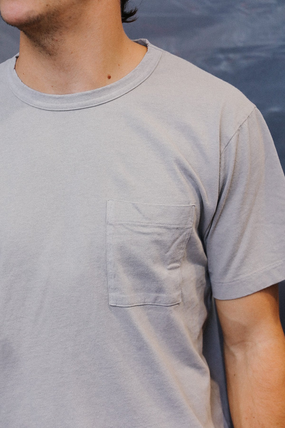 man wearing a grey t-shirt