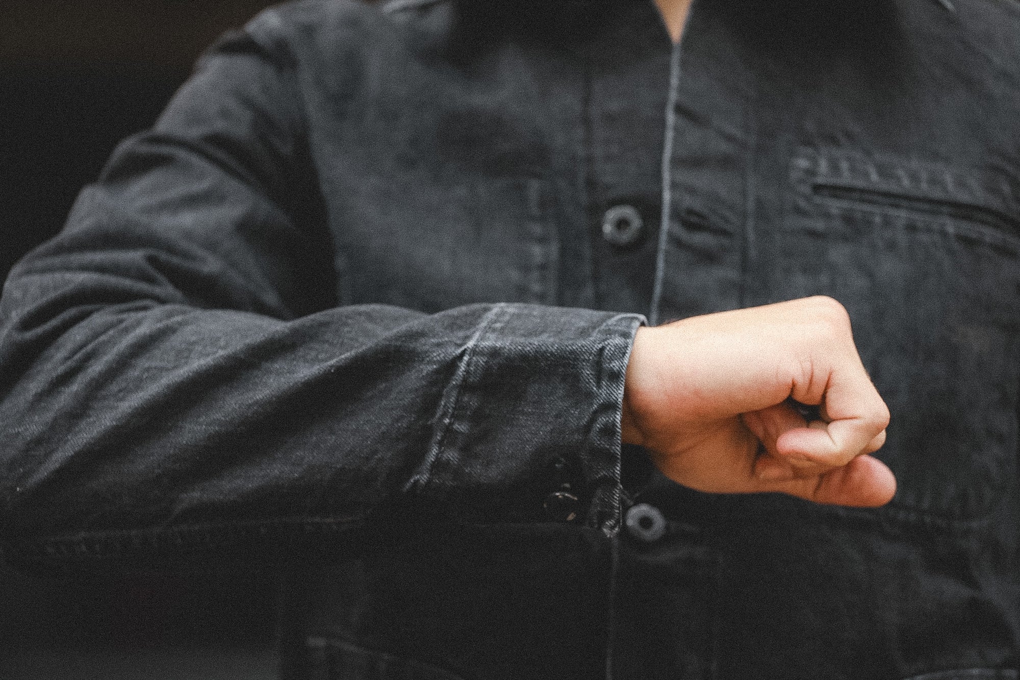 Person wearing a dark jacket with a blurred background