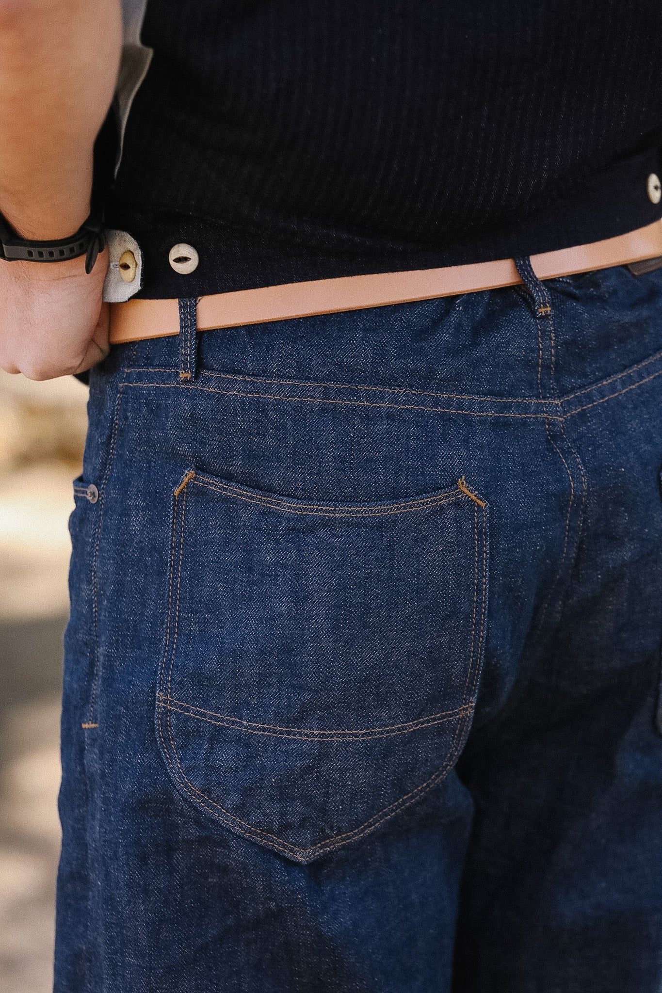 Close-up of blue jeans with a focus on the back pocket.