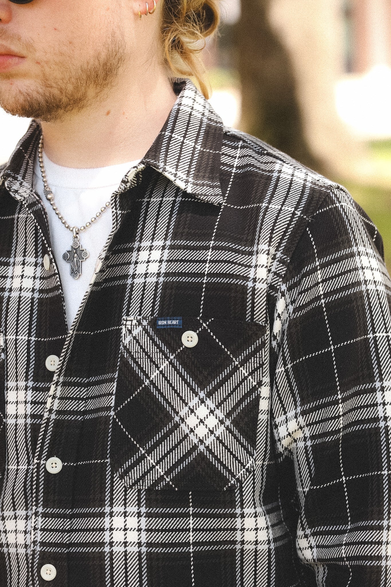detail of plaid black shirt outdoors on a blurred background 