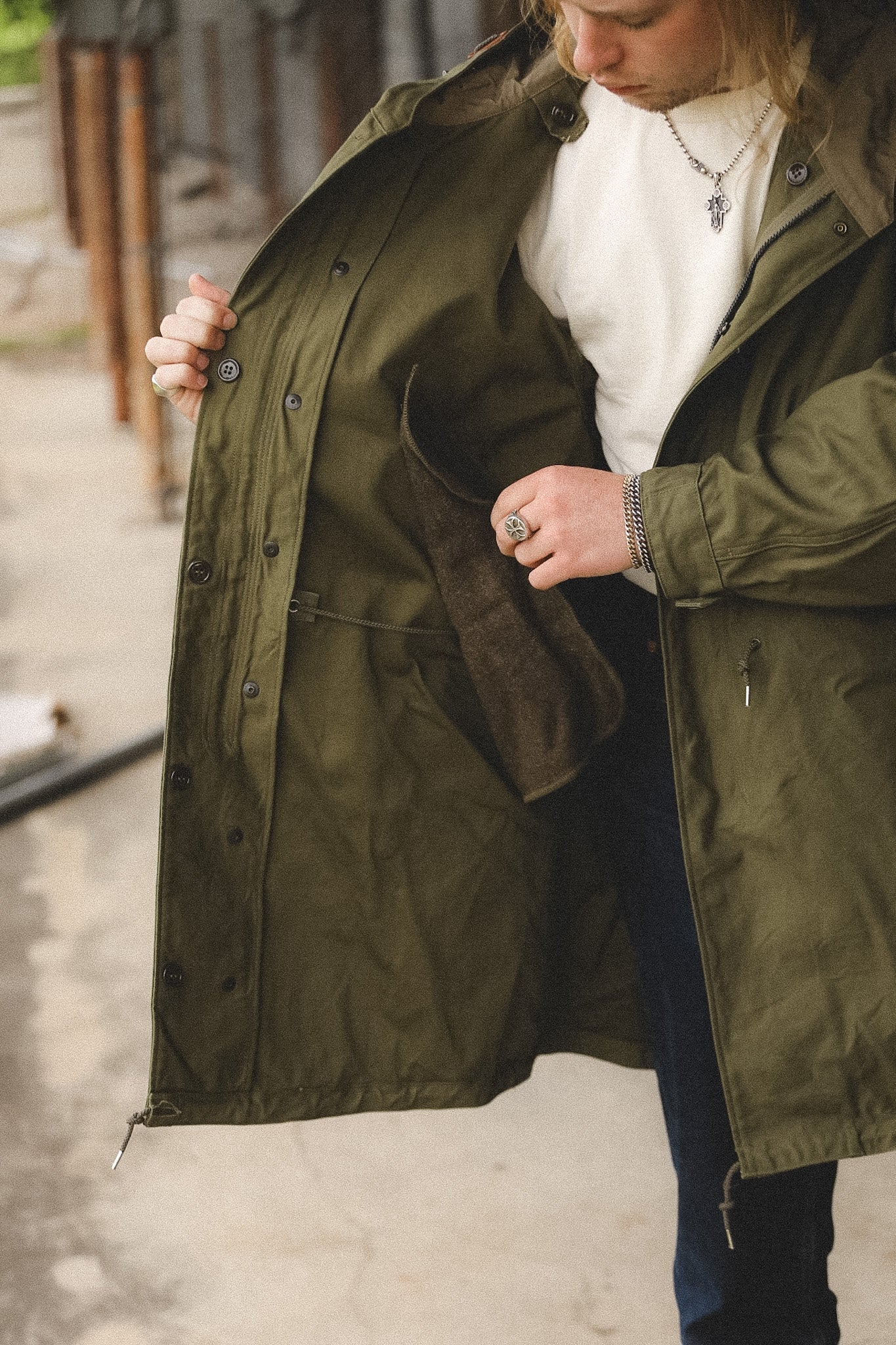 Person wearing a green coat with a blurred background