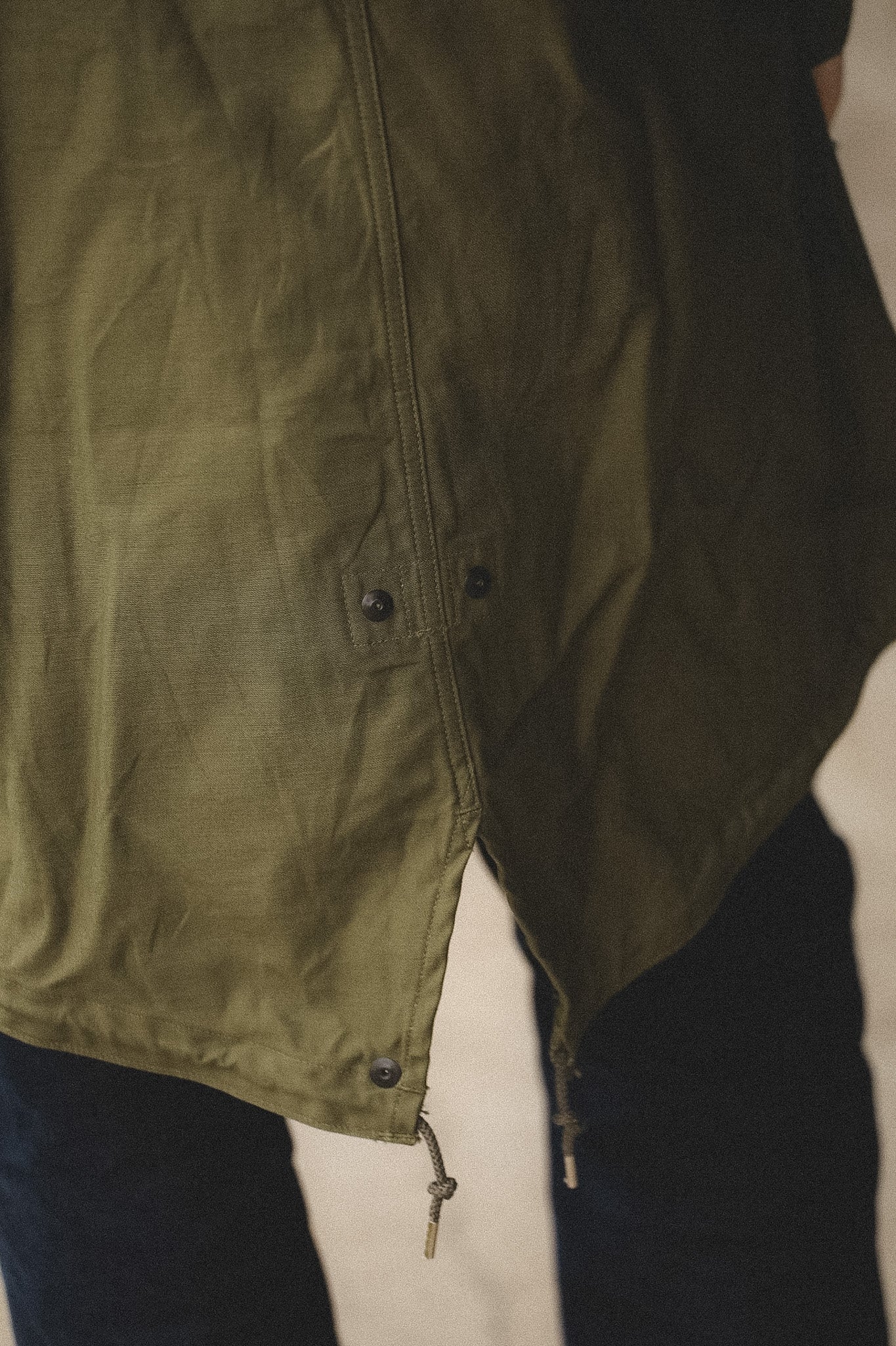 Close-up of a green jacket with a neutral background
