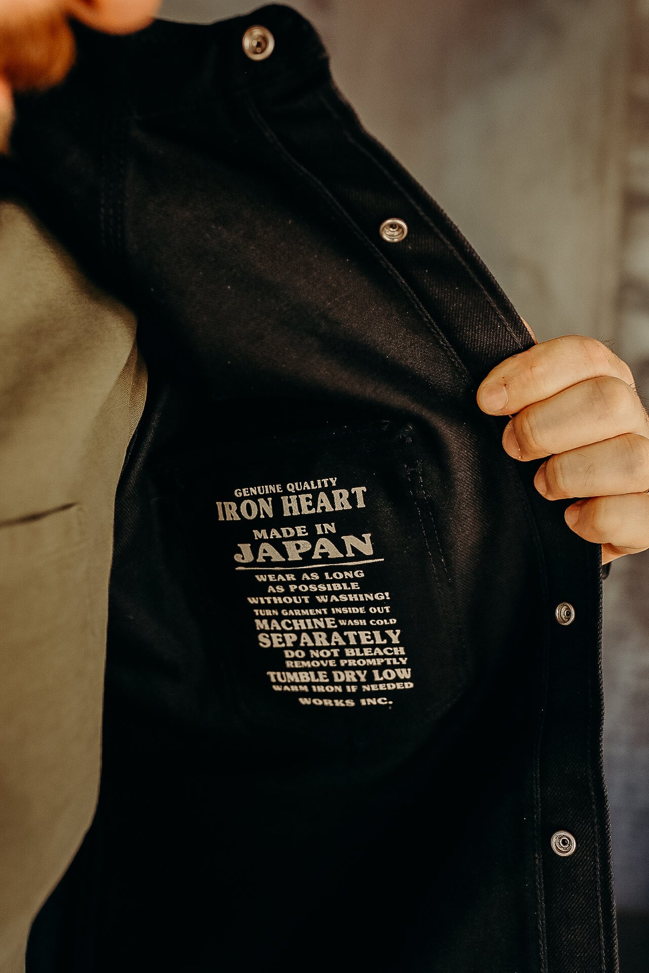 Close-up of black Iron Heart jacket label made in Japan with care instructions inside garment