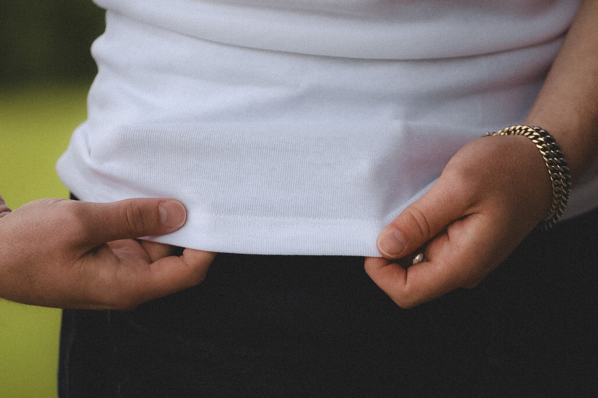 Person wearing a white shirt with a blurred background