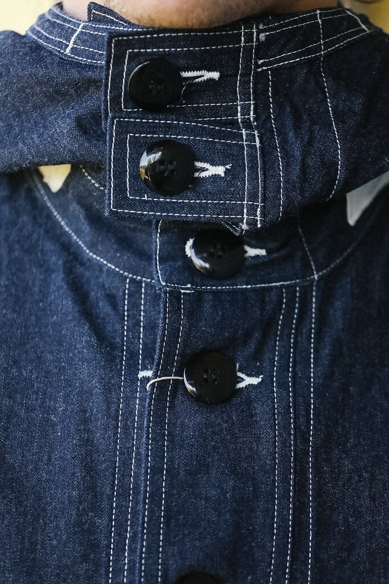 Close-up of a blue denim jacket with button details