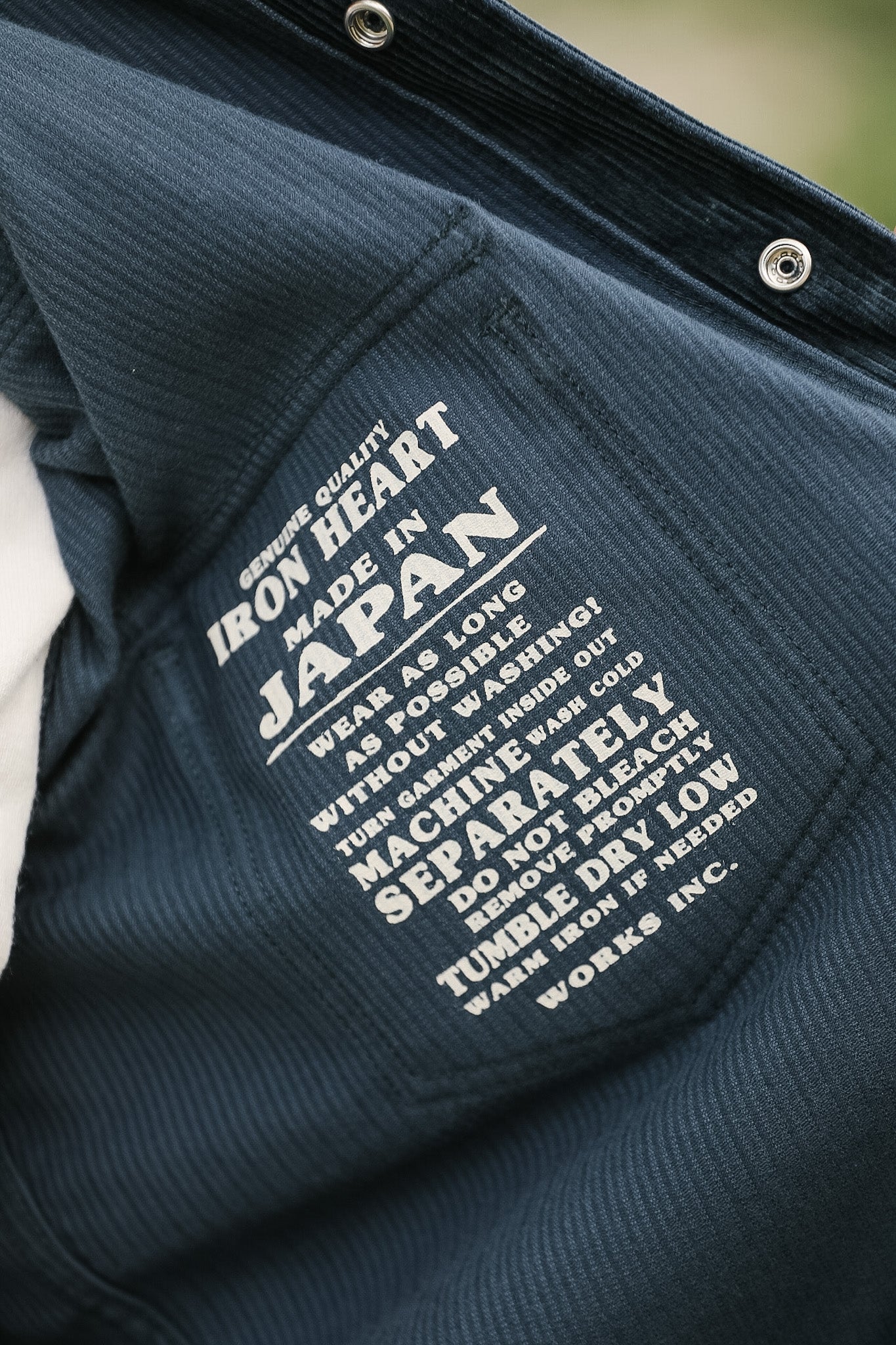 Navy jacket with white text on a blurred background