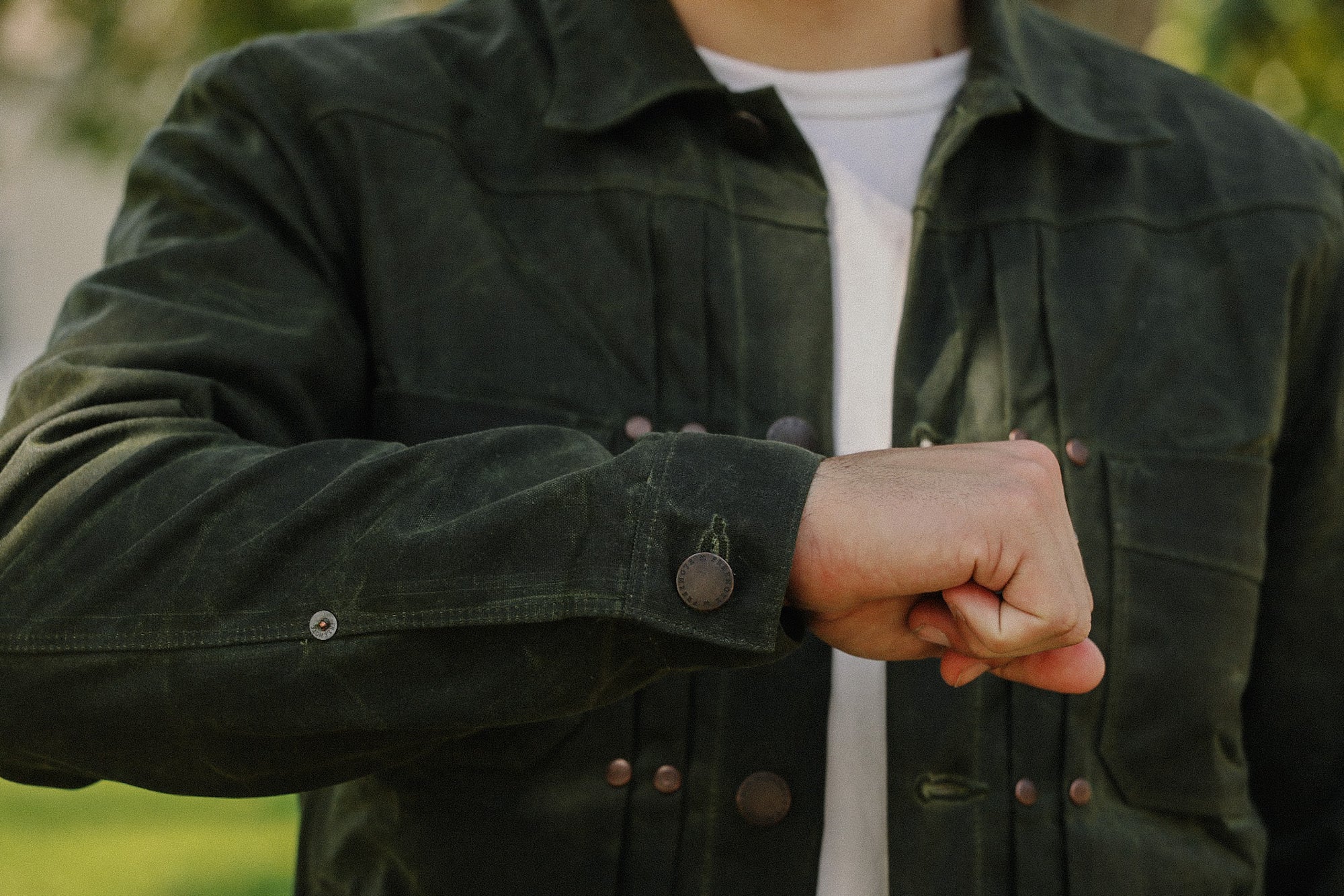 Man wearing dark green rugged work jacket from Iron Shop Provisions outdoors