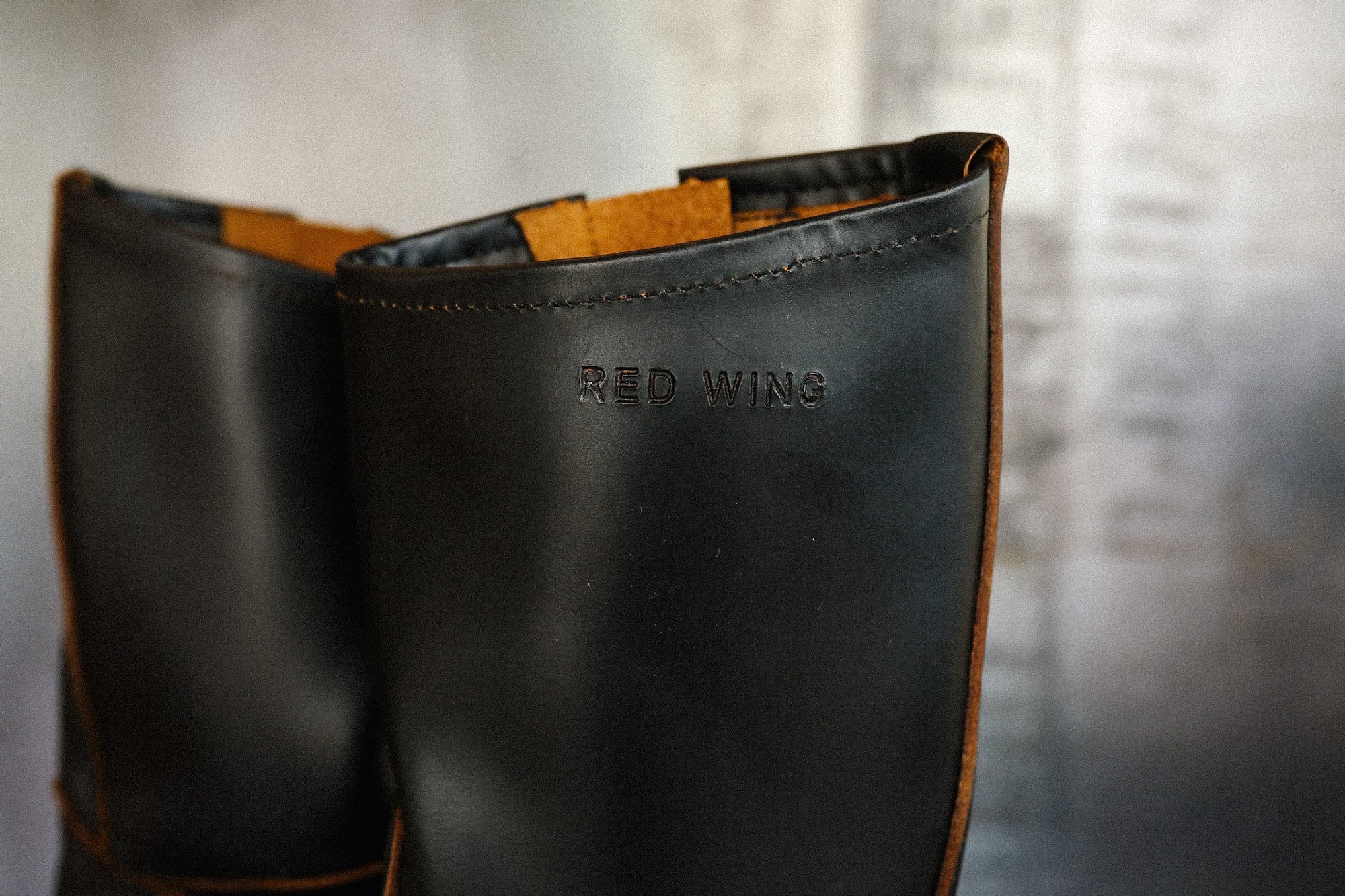 Close-up of black leather Red Wing boots with visible stitching and embossed brand name
