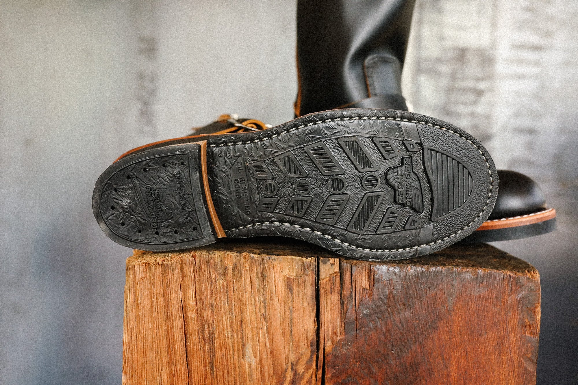 Close-up of Red Wing Boots outsole showing oil-resistant cord sole detail on wooden block