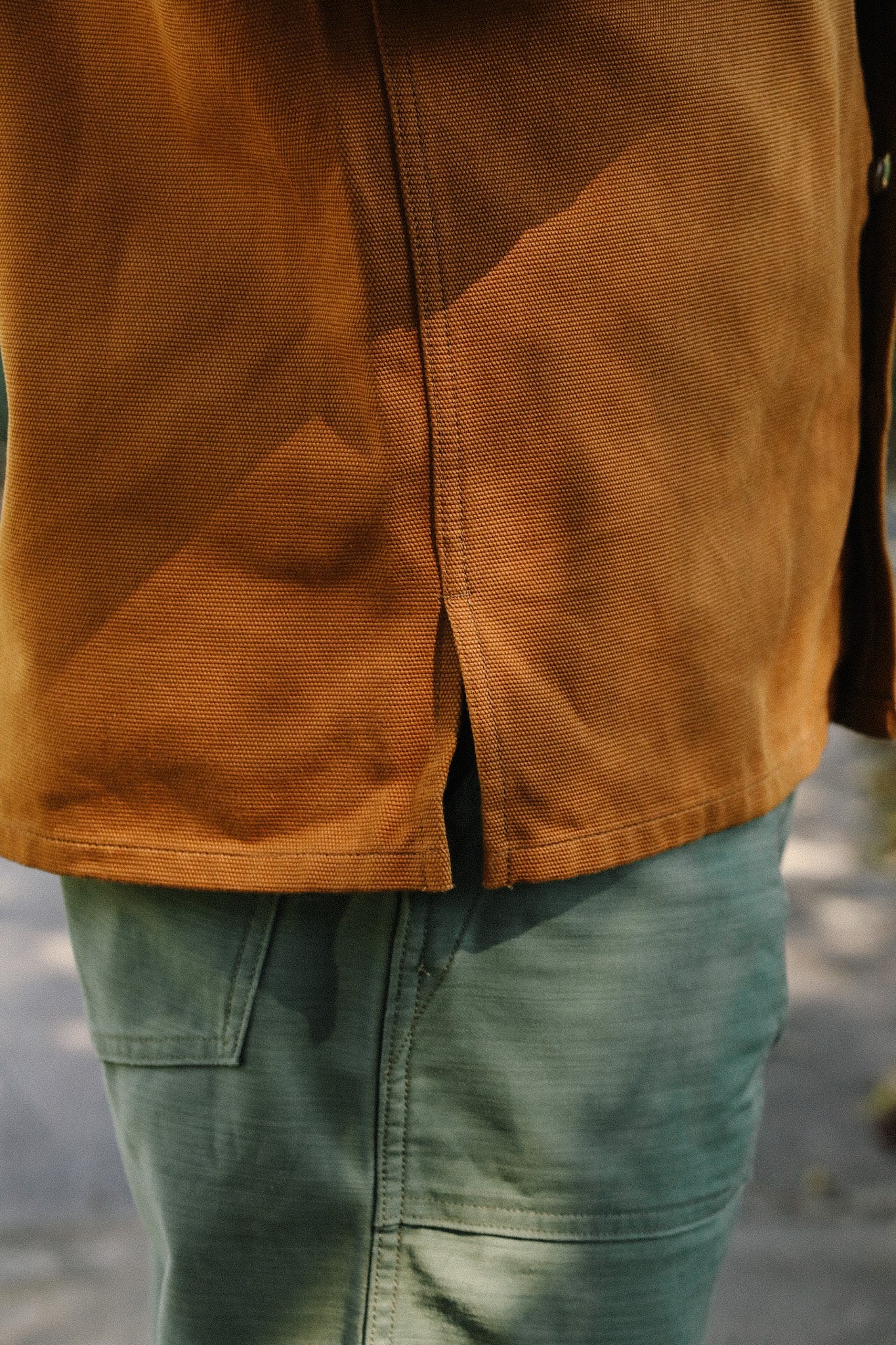 Close-up of durable brown work shirt and green utility pants from Iron Shop Provisions