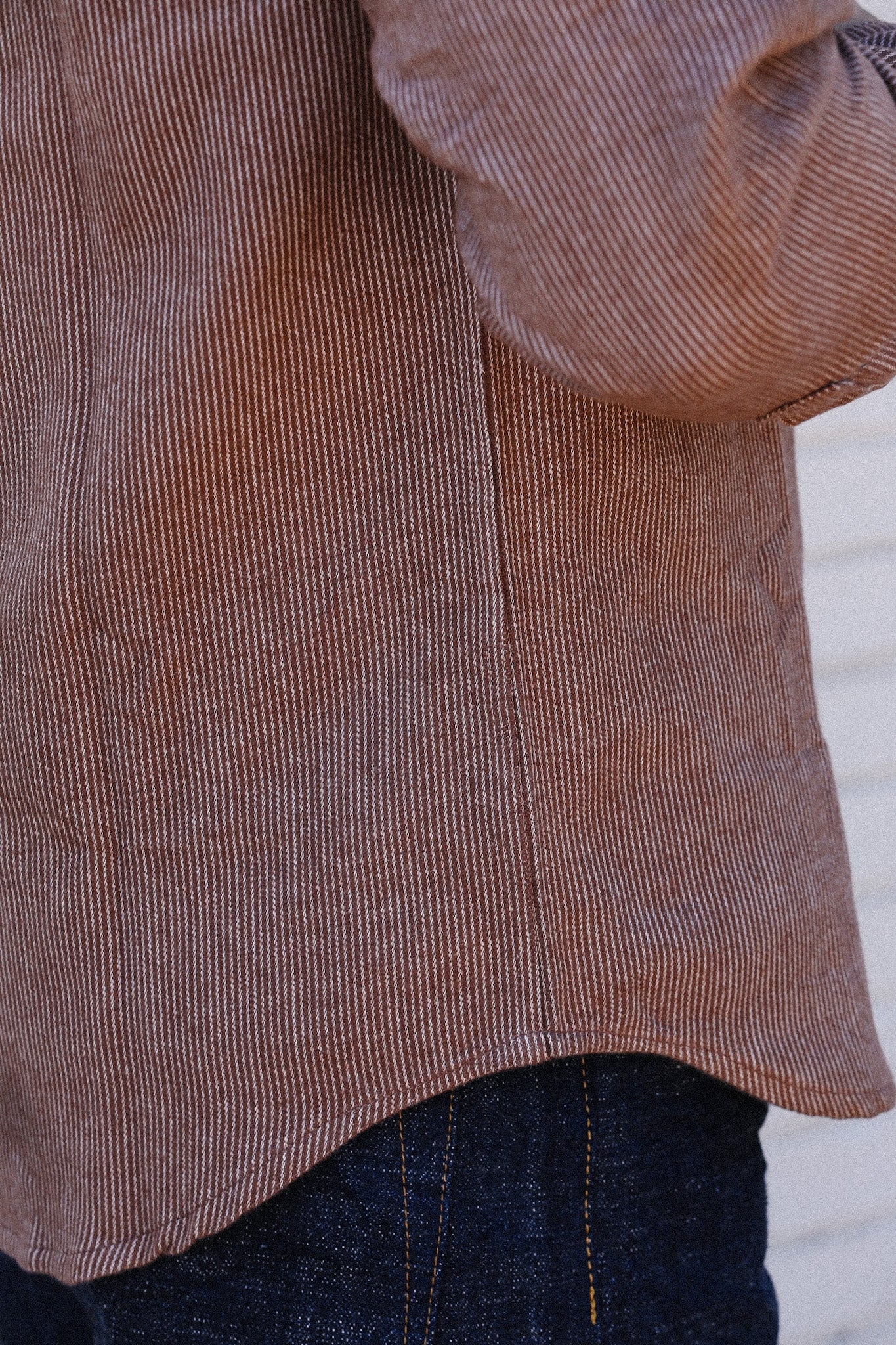 Close-up of striped brown work shirt over dark blue denim jeans from Iron Shop Provisions