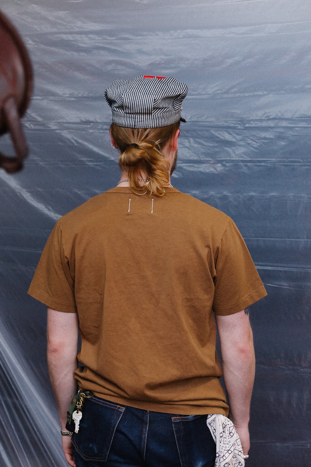 man wearing brown t-shirt with a pocket