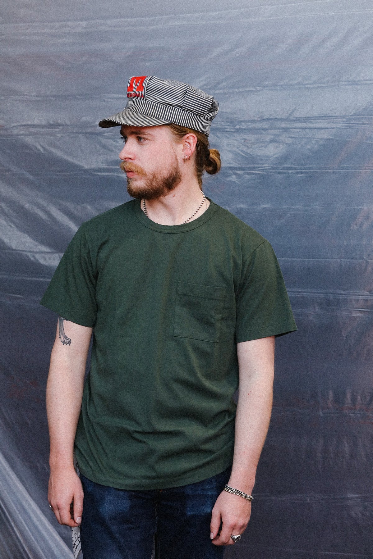 man wearing green t-shirt with a pocket
