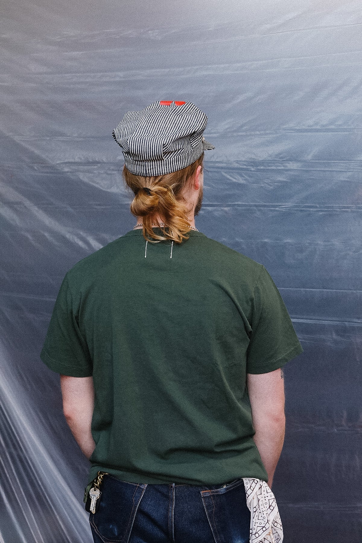 man wearing green t-shirt with a pocket