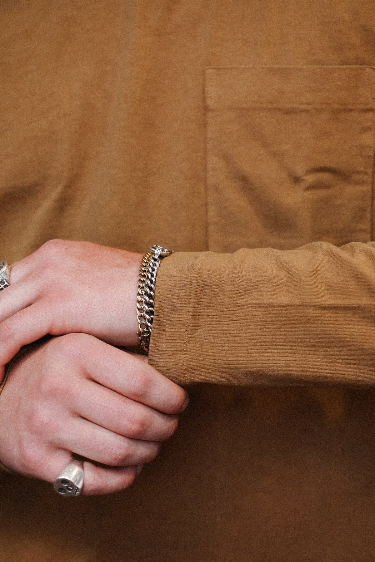 close up detail of brown long sleeve t-shirt