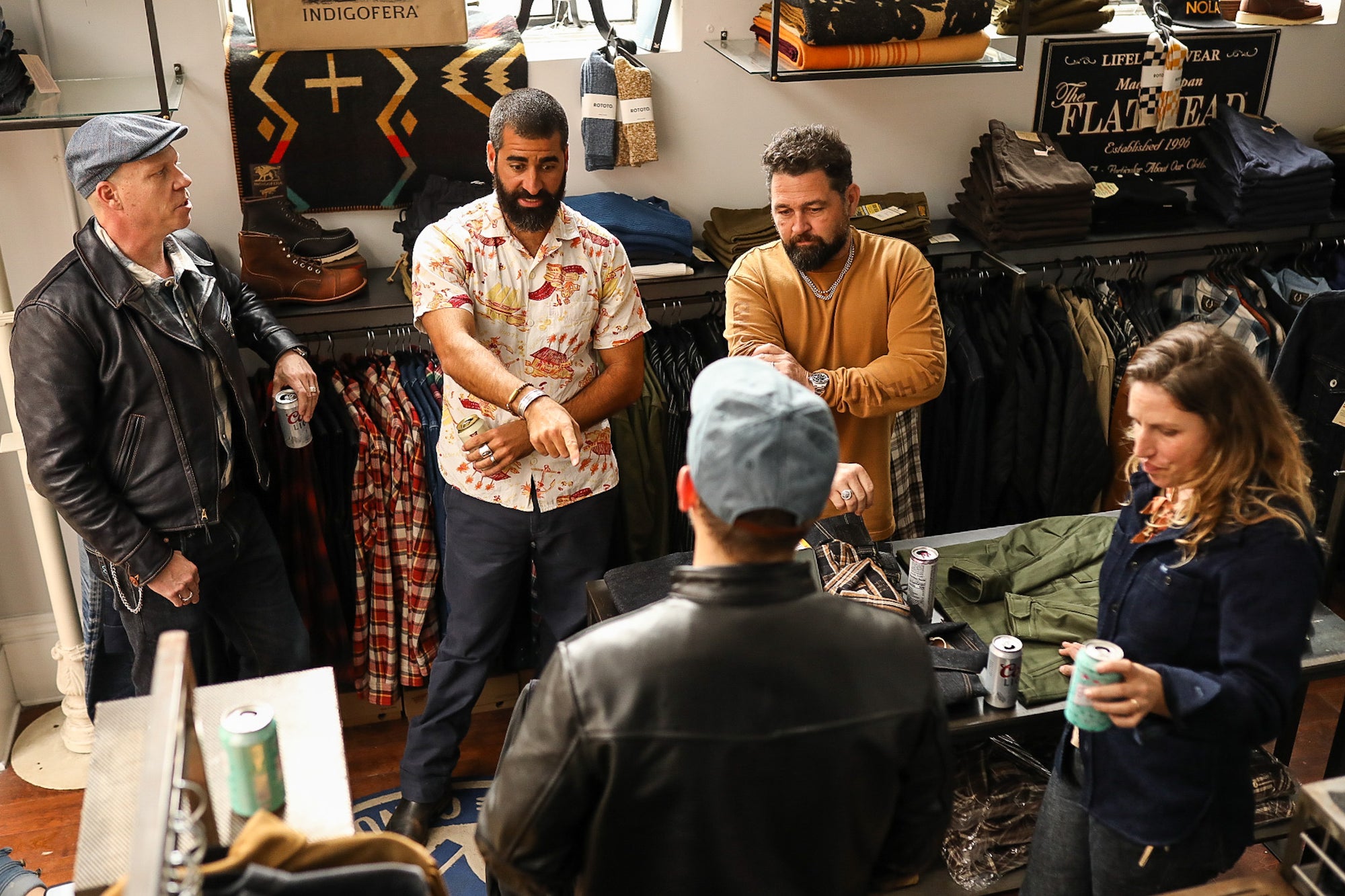 group of people standing around talking in iron shop nola store 