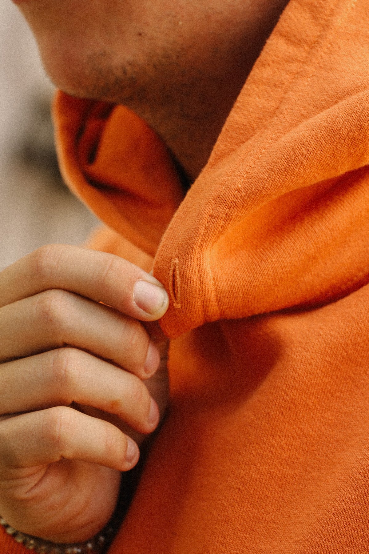 close up detail of a orange sweater