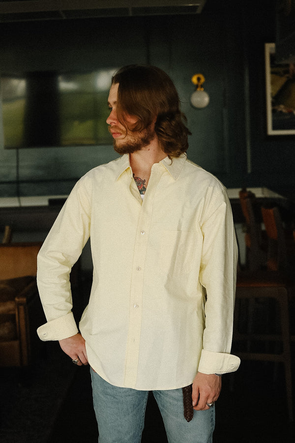 Man wearing a light-colored shirt in an indoor setting