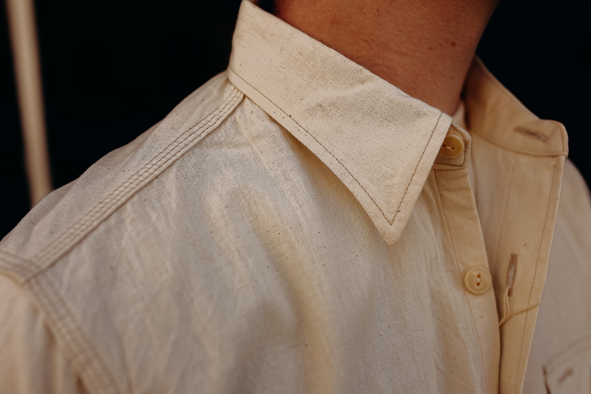 Close-up of a beige canvas work shirt with collar and button details from Iron Shop Provisions