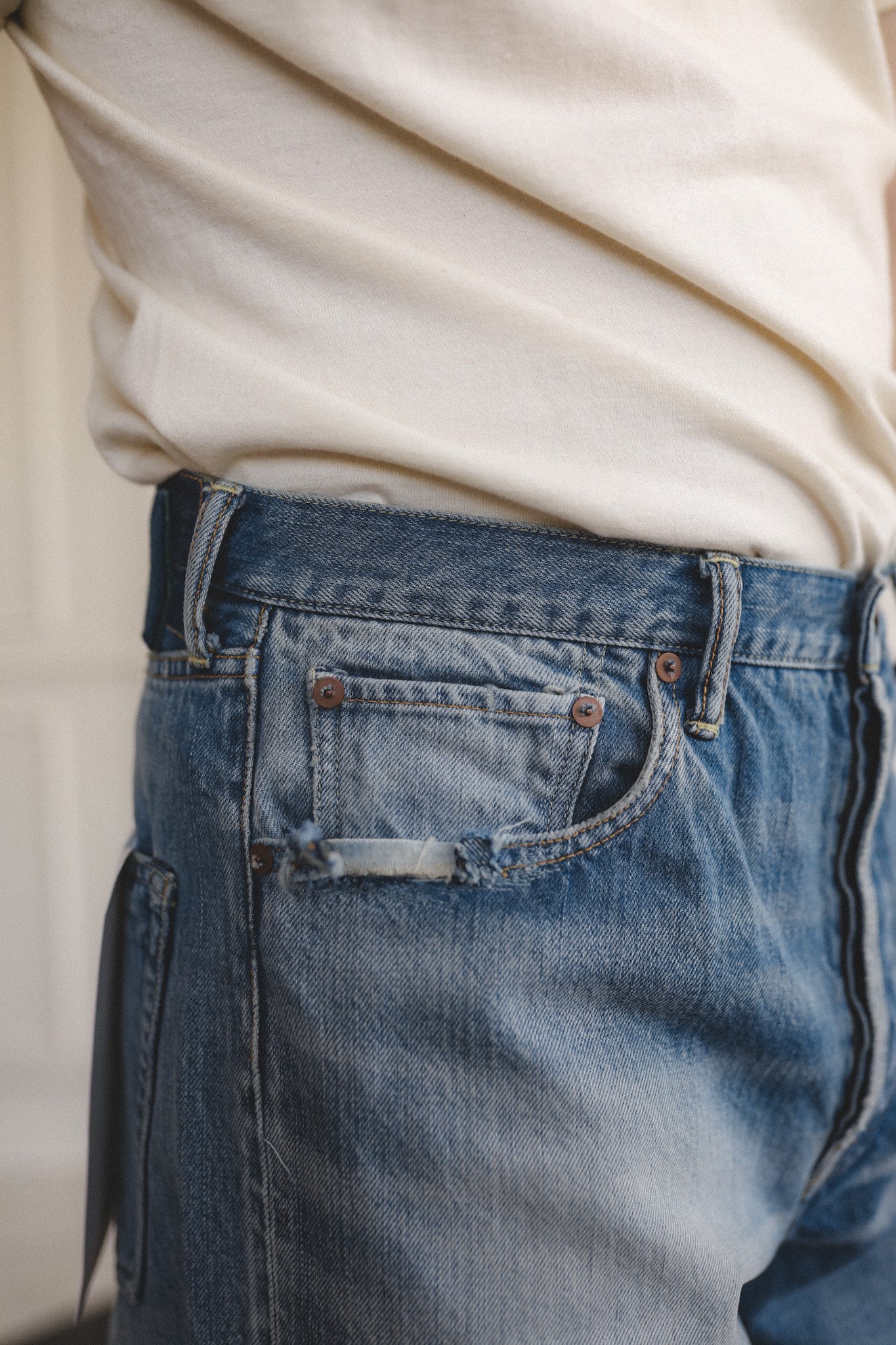 Close-up of blue jeans with a neutral background