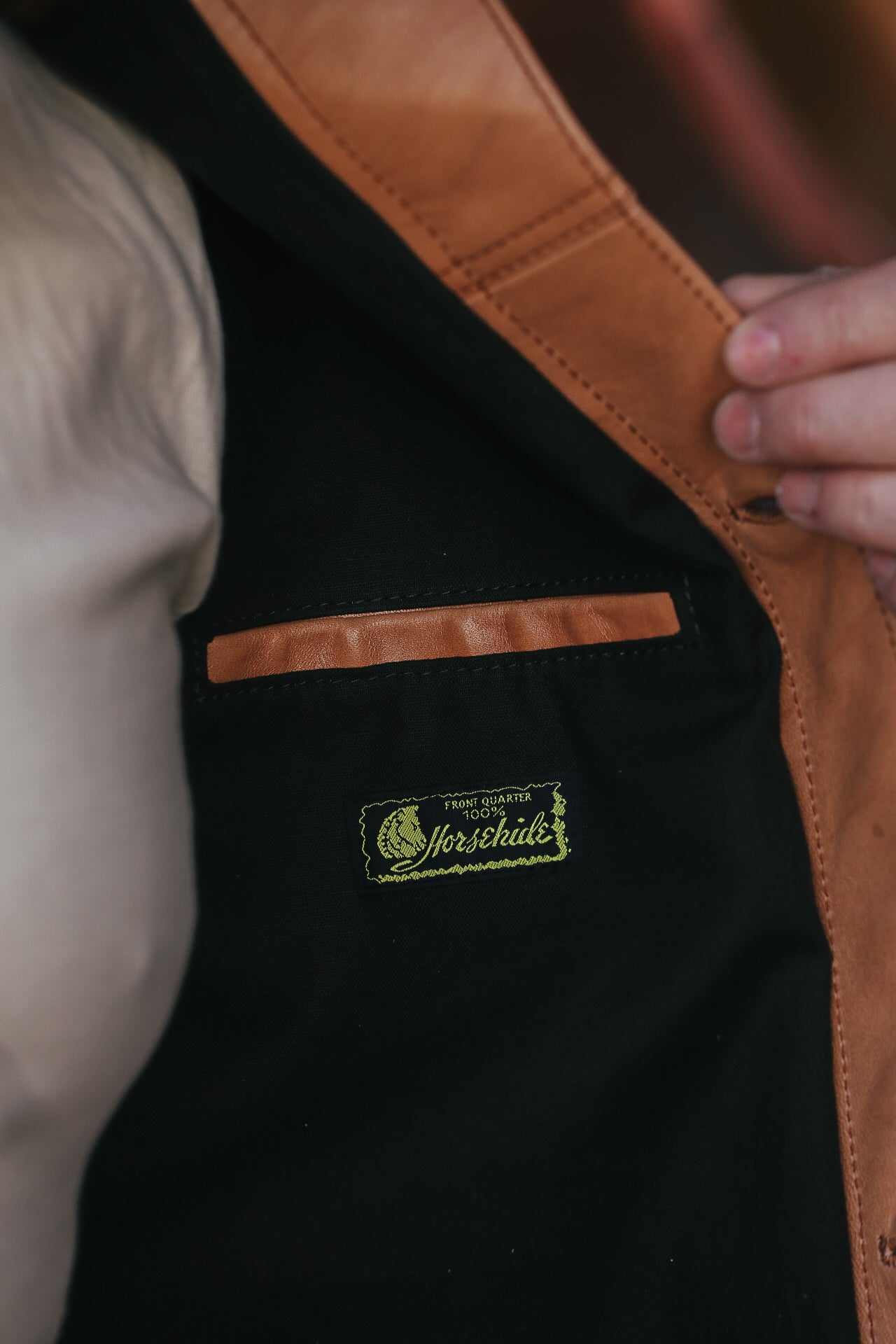 Man wearing leather jacket with white shirt . pocket detail.  
