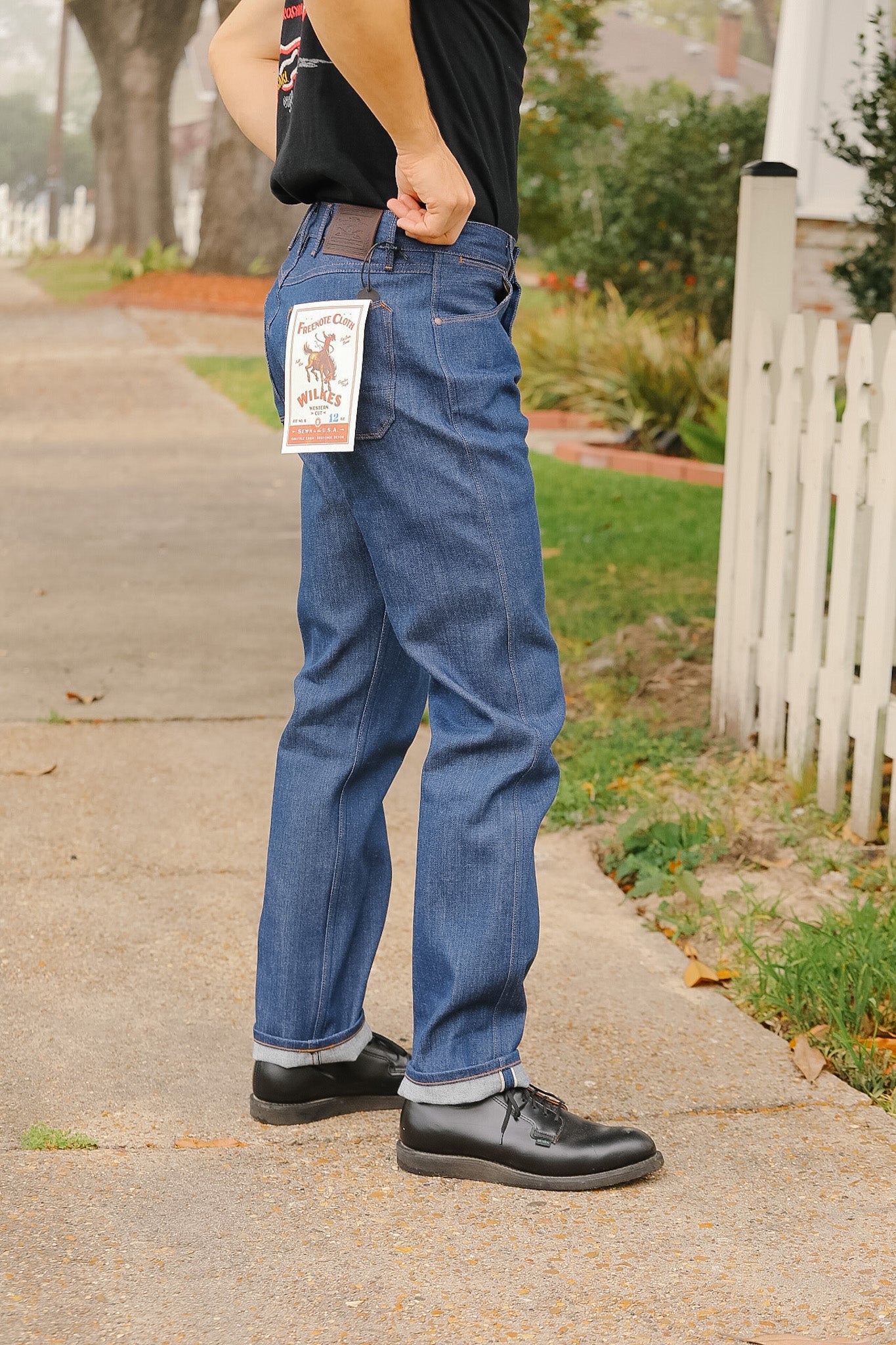 man wearing light blue jeans on sidewalk 