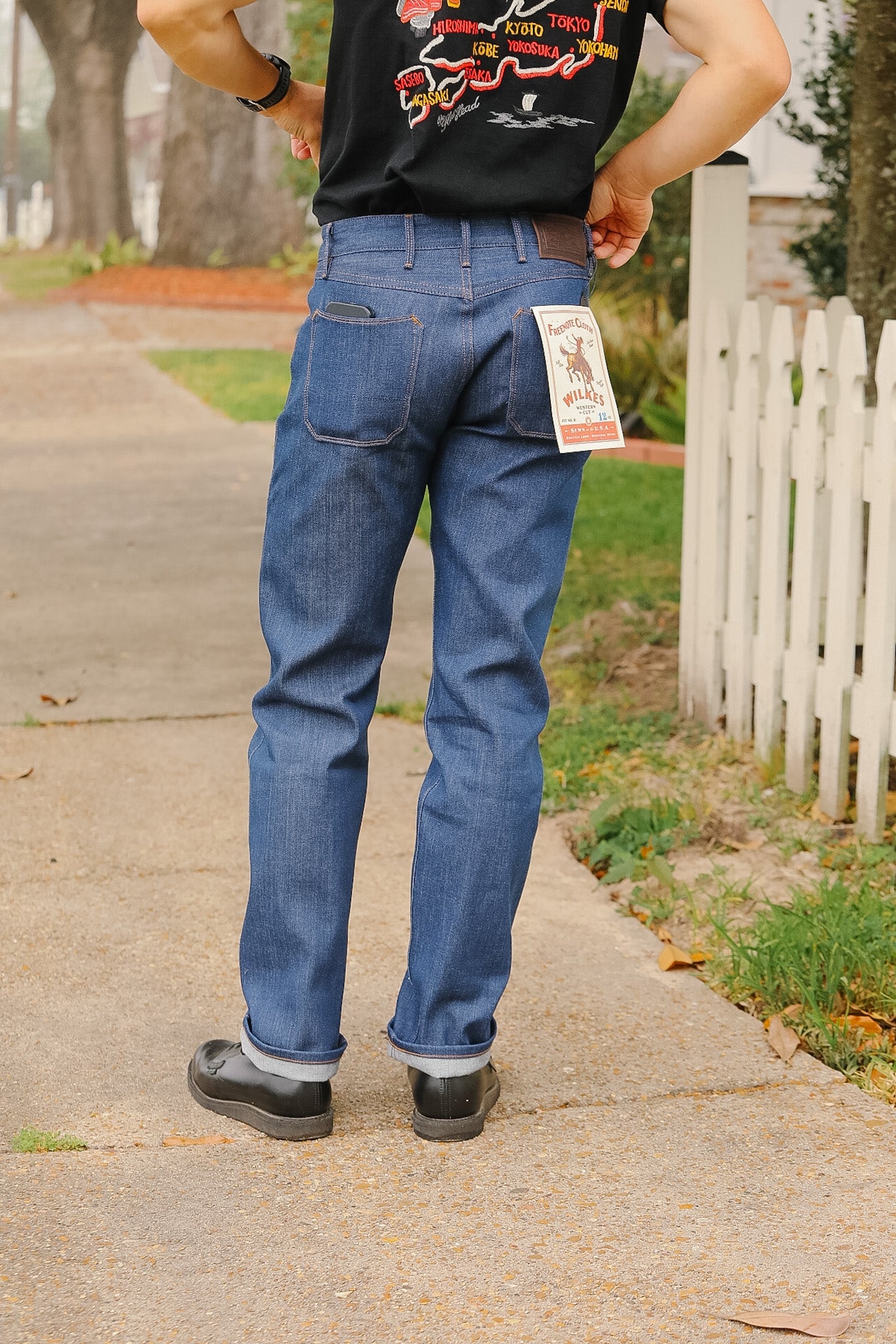 man wearing light blue jeans on sidewalk 