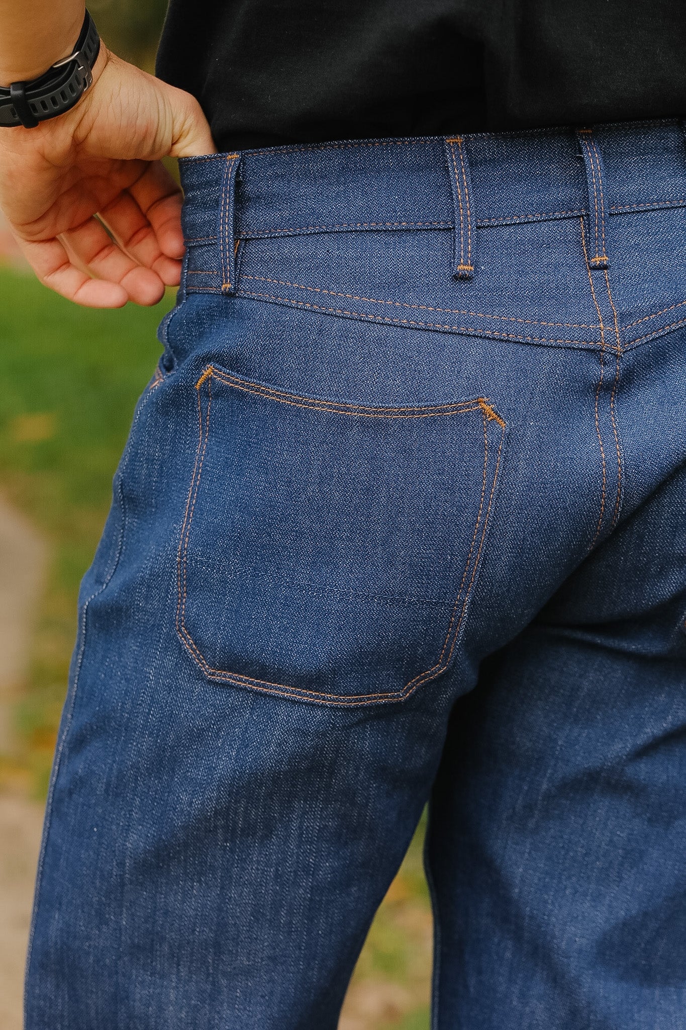man wearing light blue jeans on sidewalk 