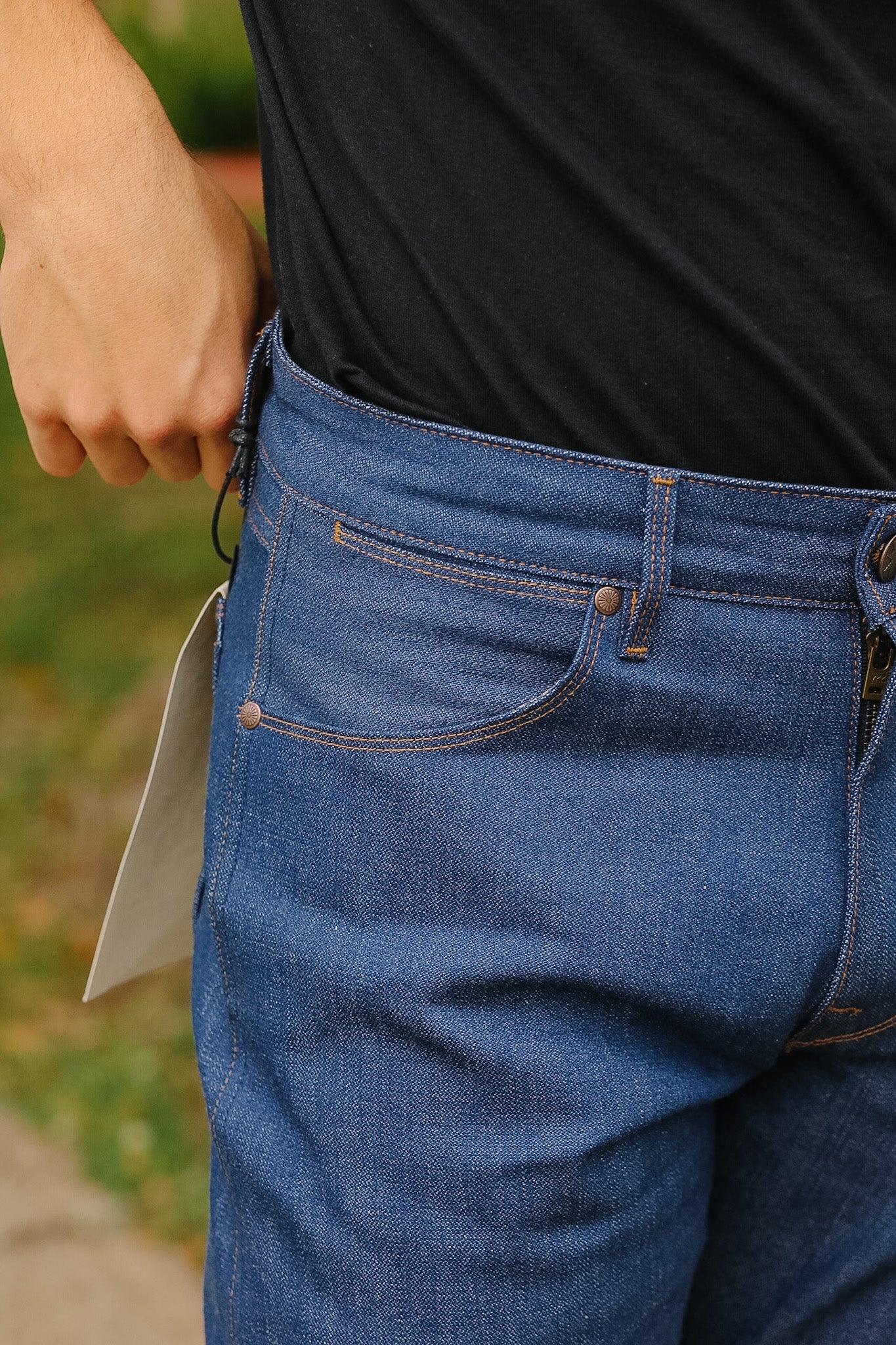 man wearing light blue jeans on sidewalk 