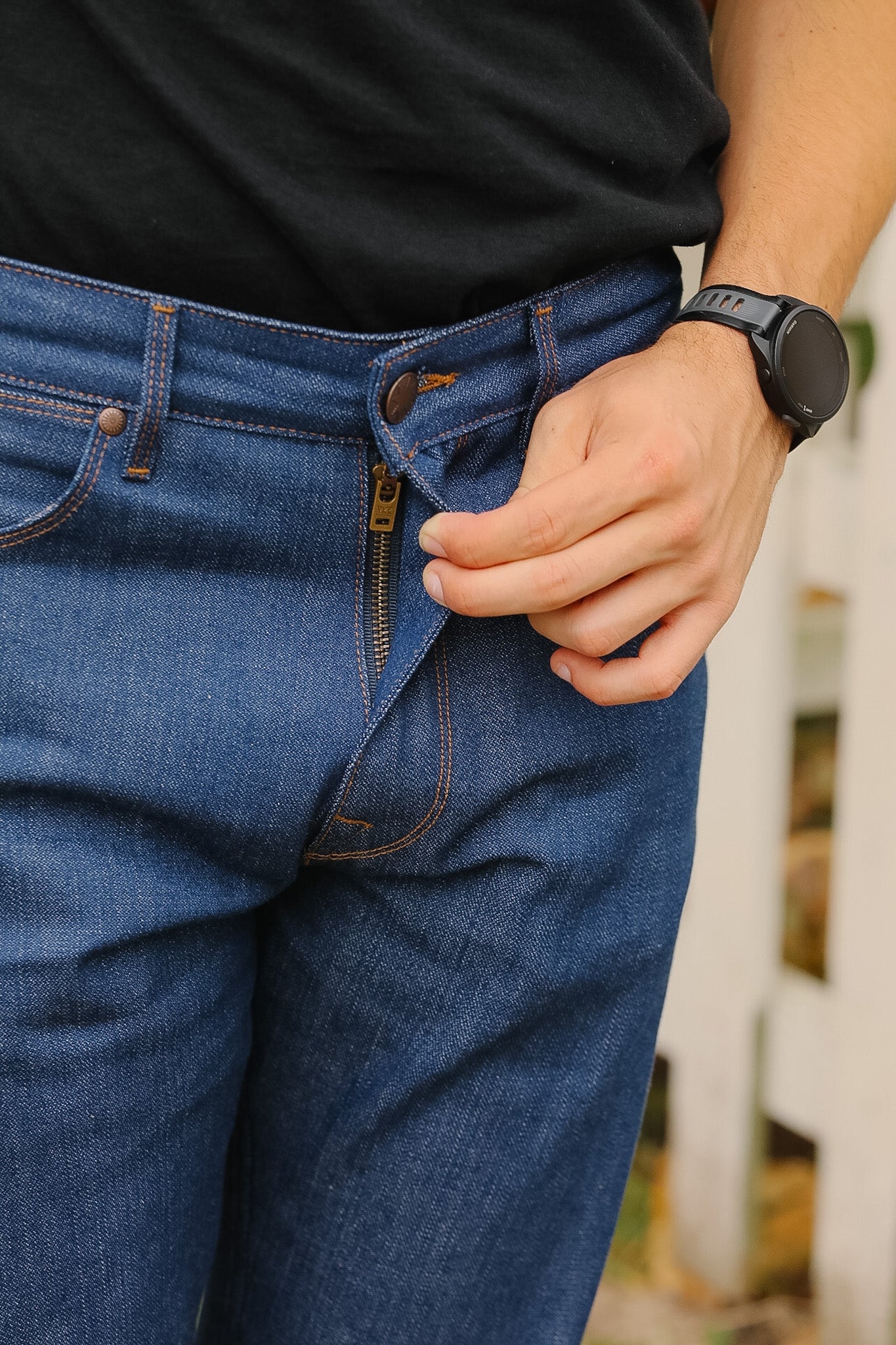 man wearing light blue jeans on sidewalk 