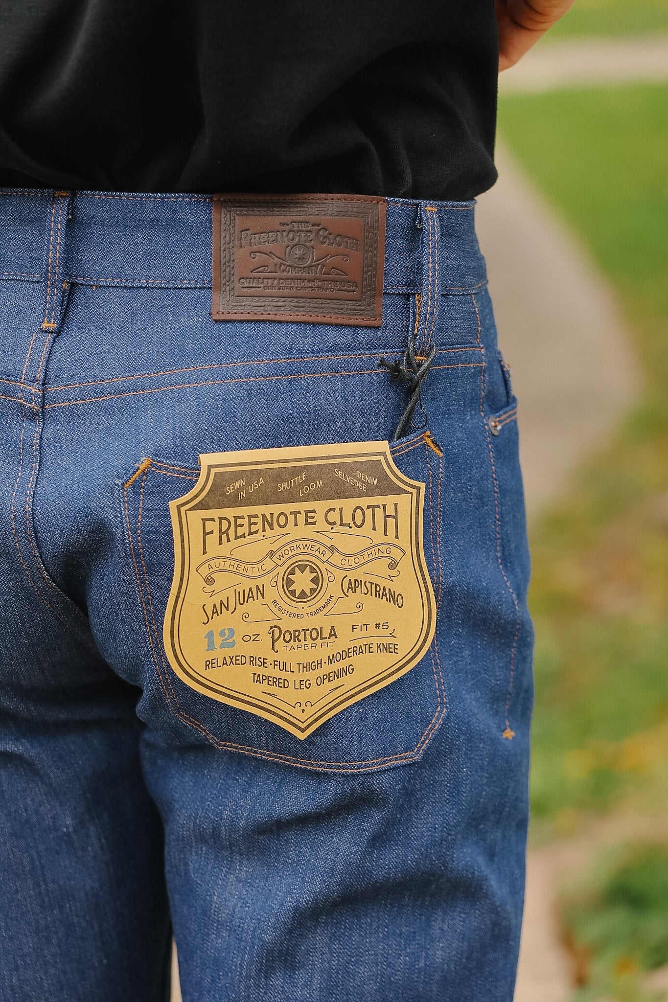Blue jeans with a visible brand label on the back pocket, outdoors.